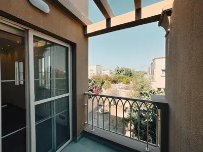 a balcony with a sliding glass door with a view at The Springs 14-Charming 2-Bedroom Villa in By Al sarya Holiday Home in Dubai