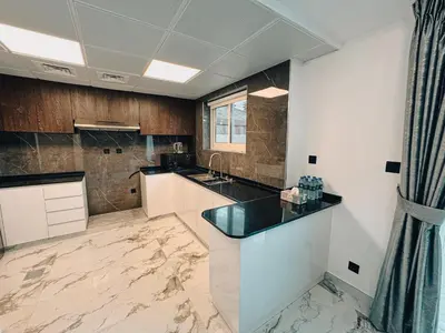 a large kitchen with a counter and a sink at The Springs 14-Charming 2-Bedroom Villa in By Al sarya Holiday Home in Dubai