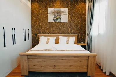 a bedroom with a wooden bed with white sheets at The Springs 14-Charming 2-Bedroom Villa in By Al sarya Holiday Home in Dubai
