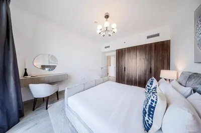 a bedroom with a white bed and a couch at New 1 BD in Madinat Jumeirah Living in Dubai
