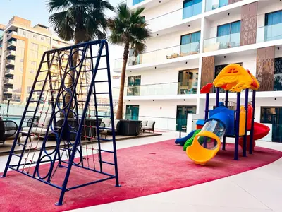 a playground in front of a building at Stylish 1-Bedroom Retreat in Prime Gardens , Arjan in Dubai