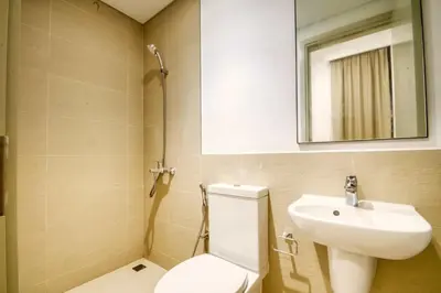 a bathroom with a toilet and a sink and a mirror at Dubai dream villa Emaar in Dubai
