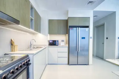 a kitchen with a stainless steel refrigerator in it at Dubai dream villa Emaar in Dubai