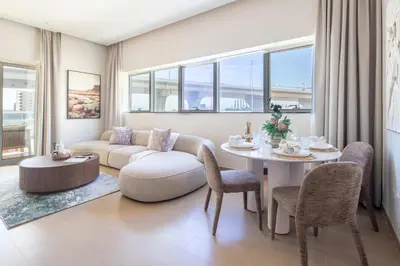 a living room with a couch and a table at Frank Porter - Zen Tower in Dubai