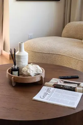 a coffee table with a tray with a book on it at Frank Porter - Zen Tower in Dubai
