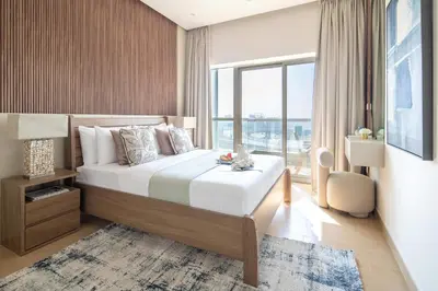 a bedroom with a large bed and a large window at Frank Porter - Zen Tower in Dubai