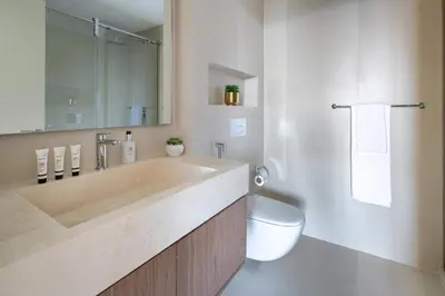 a bathroom with a large sink and a toilet at Frank Porter - Zen Tower in Dubai