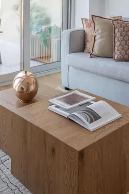 a coffee table in a living room with a book on it at Frank Porter - Palm Views East in Dubai