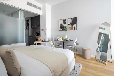 a bedroom with a large bed and a table at Frank Porter - Palm Views East in Dubai