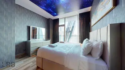 a bedroom with a bed with a star ceiling at Stunning 2-Bed Apartment with Canal View in Dubai