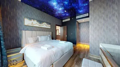 a bedroom with a large bed with a star ceiling at Stunning 2-Bed Apartment with Canal View in Dubai
