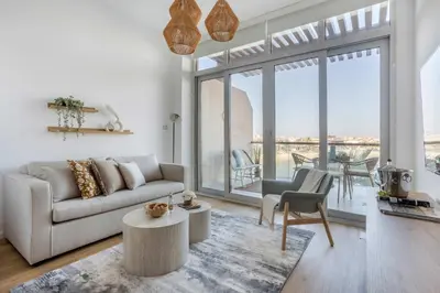a living room with a couch and a table at Frank Porter - Palm Views East in Dubai
