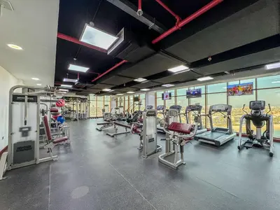 a gym with a lot of treadms and machines at Frank Porter - Palm Views East in Dubai