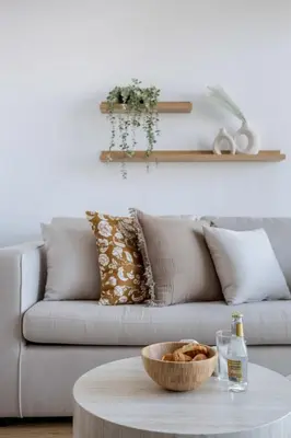 a living room with a couch and a bowl on a table at Frank Porter - Palm Views East in Dubai