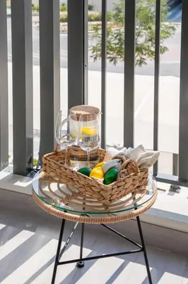 a basket of fruit on a table in front of a window at Frank Porter - Legacy by Sunrise in Dubai
