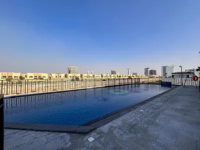a large swimming pool with a city in the background at Frank Porter - Legacy by Sunrise in Dubai