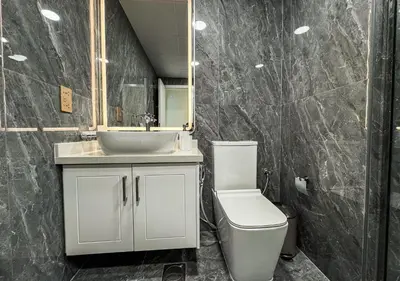 a bathroom with a sink and a toilet and a mirror at DreamShoma-3BR Super Luxurious The Residence 5 Downtown in Dubai