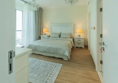 a white bedroom with a bed and a window at DreamShoma-3BR Super Luxurious The Residence 5 Downtown in Dubai