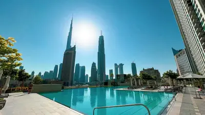 a large swimming pool in the middle of a city at Downtown Dreams Burj Khalifa View with Dubai Mall, Pool & Free Parking in Dubai