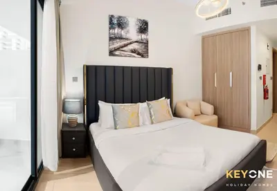 a bedroom with a large bed with a black headboard at Azizi Riviera Studio with Chic Furnishing in Dubai