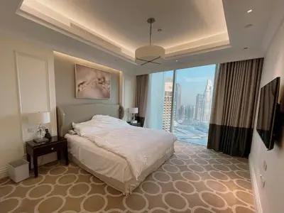 a hotel room with a bed and a large window at Apt Dubai Downtown in Dubai