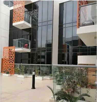 a view of a building with some plants in front of it at Live a life of luxury in Dubai