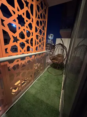 a balcony with a chair and a green floor at Live a life of luxury in Dubai