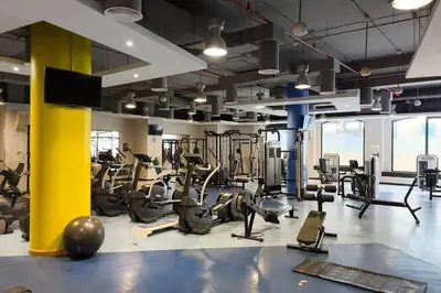a gym with treadmills and elliptical machines at Cozy 1BR apartment in JBR in Dubai