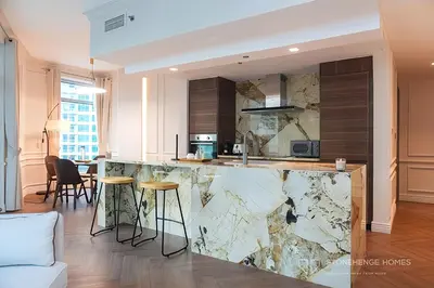 a kitchen with a marble counter and stools at Chic 1 Bedroom Apartment in Dubai Marina, Marina View, Near JBR in Dubai
