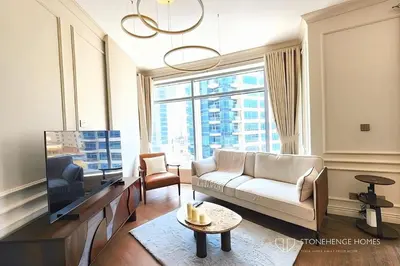 a living room with a white couch and a large window at Chic 1 Bedroom Apartment in Dubai Marina, Marina View, Near JBR in Dubai