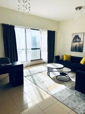 a living room with a couch and a table at JBR bed-space in Dubai