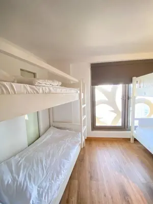 a bedroom with two bunk beds and a window at JBR bed-space in Dubai