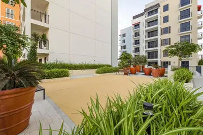 a courtyard in a building with plants and buildings at Luxury lifestyle at La Sirene Port de la Mer Jumeirah 1 in Dubai