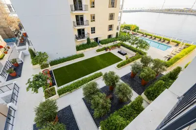 an overhead view of a courtyard with trees and a pool at Luxury lifestyle at La Sirene Port de la Mer Jumeirah 1 in Dubai