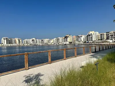 a bridge over a body of water with buildings at Luxury lifestyle at La Sirene Port de la Mer Jumeirah 1 in Dubai