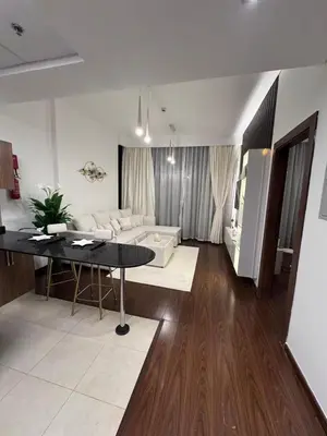a living room with a couch and a table at Brand New Apartment IN JVC in Dubai