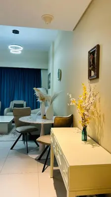 a living room with a table and chairs at MontRose Residence Tower A in Dubai