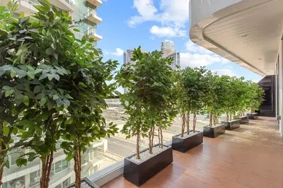 a row of potted trees on a building at Lush Living with Jacuzzi and Burj Khalifa View in Dubai