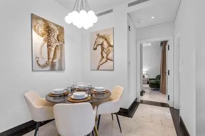 a dining room with a table and chairs at Lush Living with Jacuzzi and Burj Khalifa View in Dubai