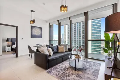 a living room with a couch and a table at Luxury 1 Bedroom in the Heart of Famous Downtown in Dubai