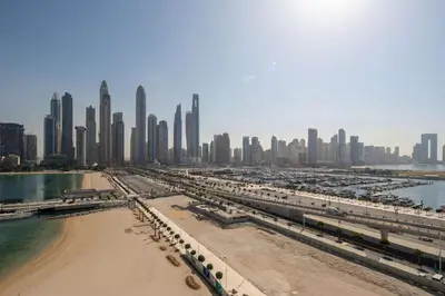 a view of a city with a beach and buildings at Frank Porter - Sunrise Tower in Dubai