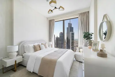 a white bedroom with a white bed and a large window at 1BR Forte 2, Skyline City View in Dubai