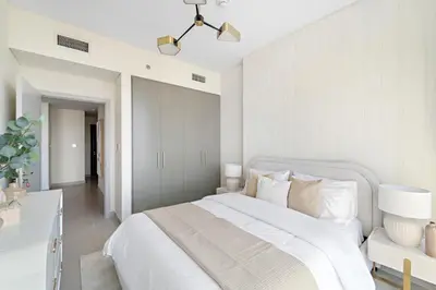 a bedroom with a white bed and a white wall at 1BR Forte 2, Skyline City View in Dubai