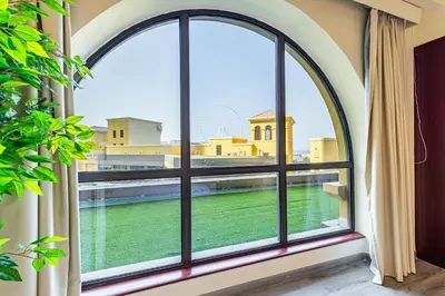 an arched window with a view of the water at Family & Group Paradise - JBR Beach 3 min walk - Ain Dubai Views - Heart of JBR - 14 People in Dubai
