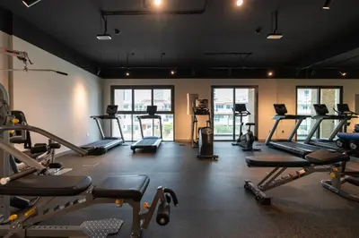 a gym with several treadmills and exercise bikes at Ahlan HH - Stunning Studio in Eleganz 2 Danube, JVC in Dubai