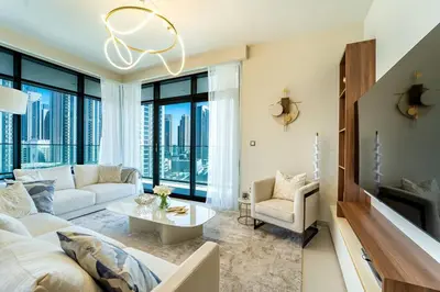 a living room with a couch and a table at NEW Exceptional Lagoon View - 2 Stylish Bedrooms in Dubai
