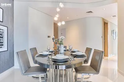 a dining room with a table and chairs at bnbmehomes - DAMAC Towers Paramount in Dubai
