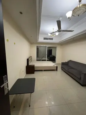 a living room with a bed and a couch at Lavish Room with family environment in Dubai