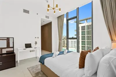 a bedroom with a bed and a large window at Superb 1 Bedroom with Burj Khalifa and Lagoon View in Dubai