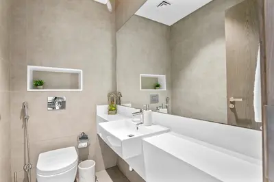 a bathroom with a white sink and a toilet at Superb 1 Bedroom with Burj Khalifa and Lagoon View in Dubai